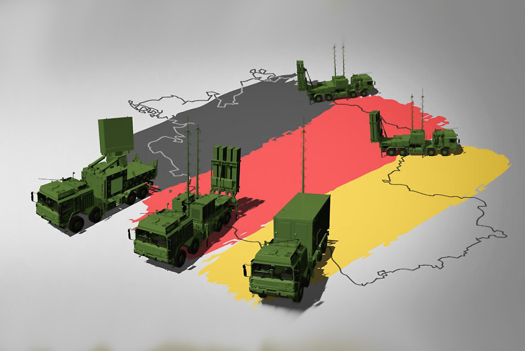 A 3D render showing the components of the German IRIS-T SLM air defense system, including a radar unit, multiple missile launcher vehicles, and a command post vehicle, positioned over a stylized map of Germany colored with the German flag.