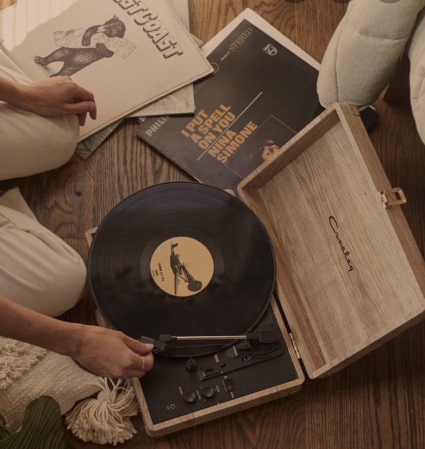 Close up of a stylus playing a black 12-inch vinyl record on a turntable