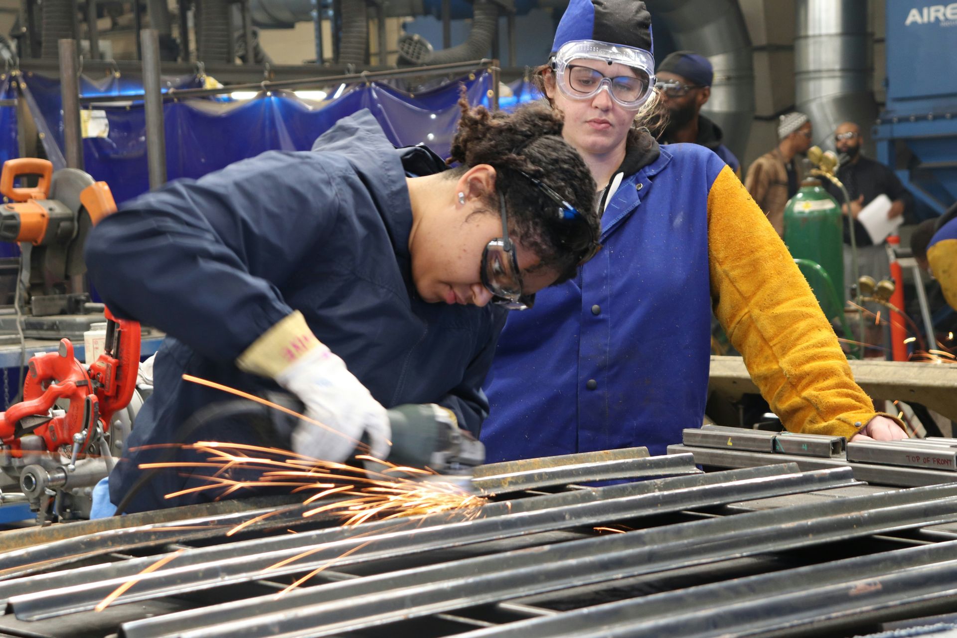 Students learning skilled trades and metal fabrication in a vocational training center